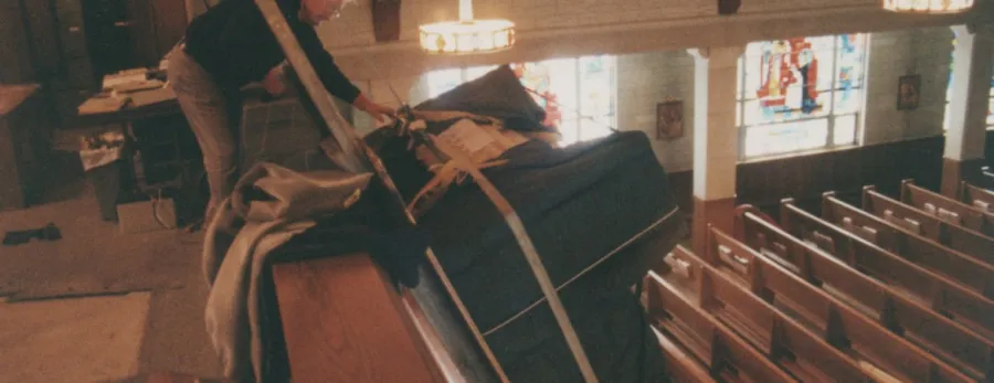 Early Meade move: a crew member wrapping a large piece inside a church hall